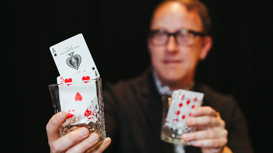 bro holding cards in glasses