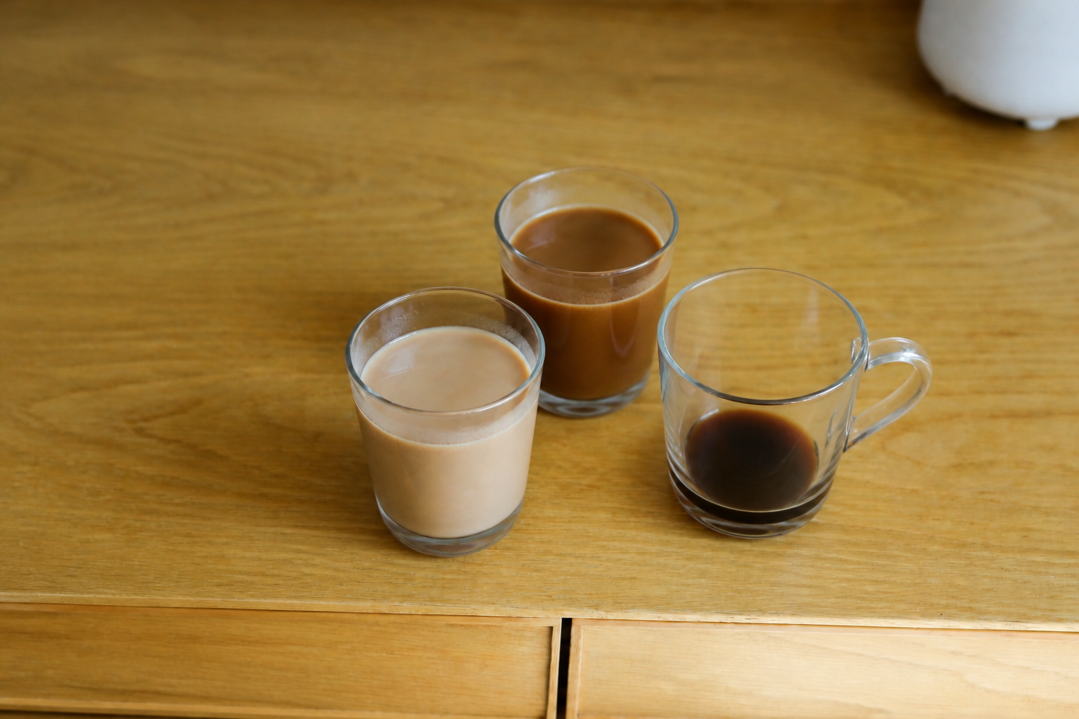 teo lattes made with different milks and one coffee
