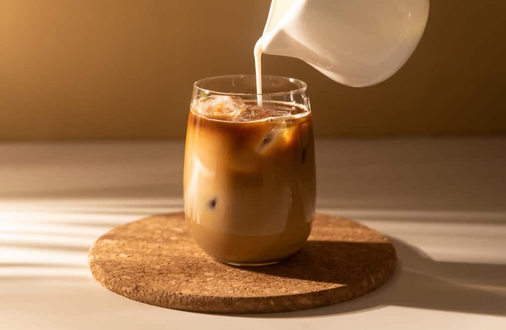 Latte being poured on table during a latte tasting virtual event