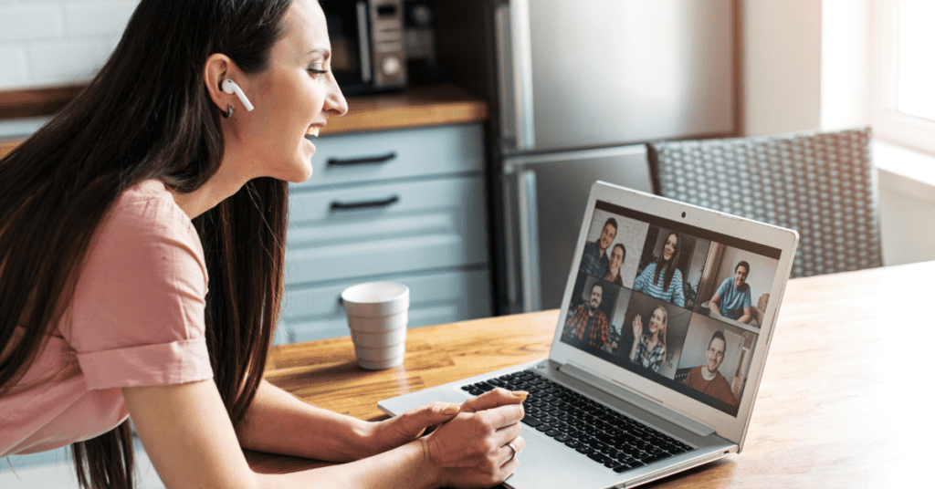 Woman in a Virtual Hosted Coffee Meeting in front of a laptop
