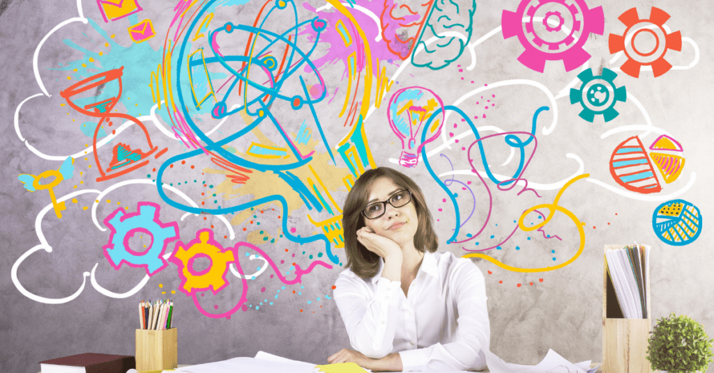 creativity - a woman with graffiti behind her at a desk